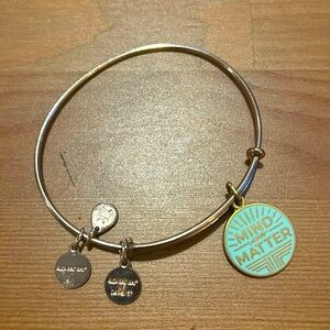 Alex and Ani copper pinch bracelet with ‘Mind Over Matter’ charm.